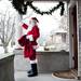 Ann Arbor Santa Claus Danny Maier waves to a neighbor before departing for Conor O'Neill's on Sunday. Daniel Brenner I AnnArbor.com
